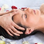 Brunette getting a head massage in the spa salon