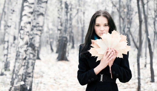 Brunette woman with maple leaves