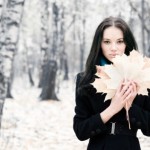 Brunette woman with maple leaves
