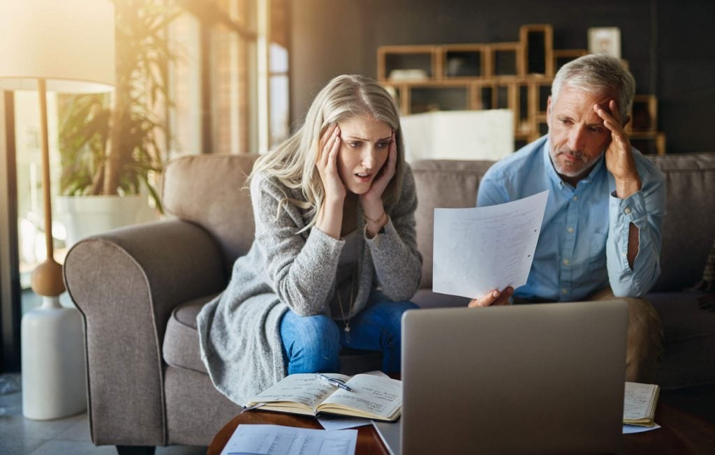 worried couple sitting on sofa, why am I so unhappy