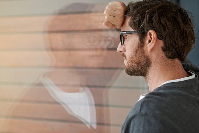 man looking out window Emotionally Unavailable man