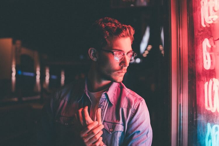 man standing by neon light silent treatment