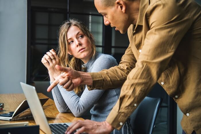 man talking to woman at work communication styles