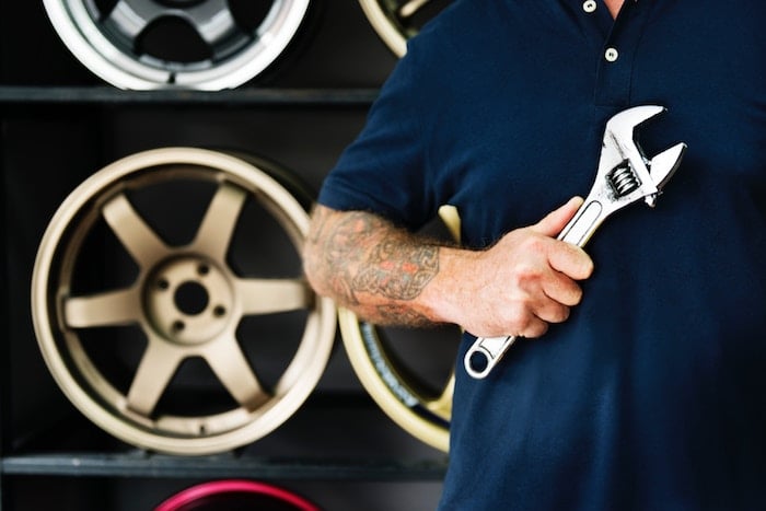 man in garage with wrench jobs for people with anxiety