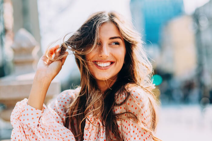 Happy woman outside how to love yourself