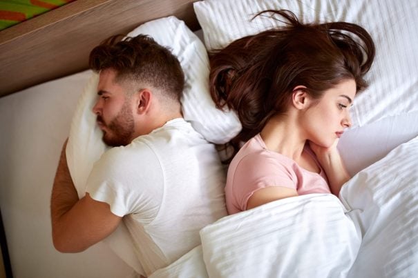 angry couple in bed, signs of gaslighting