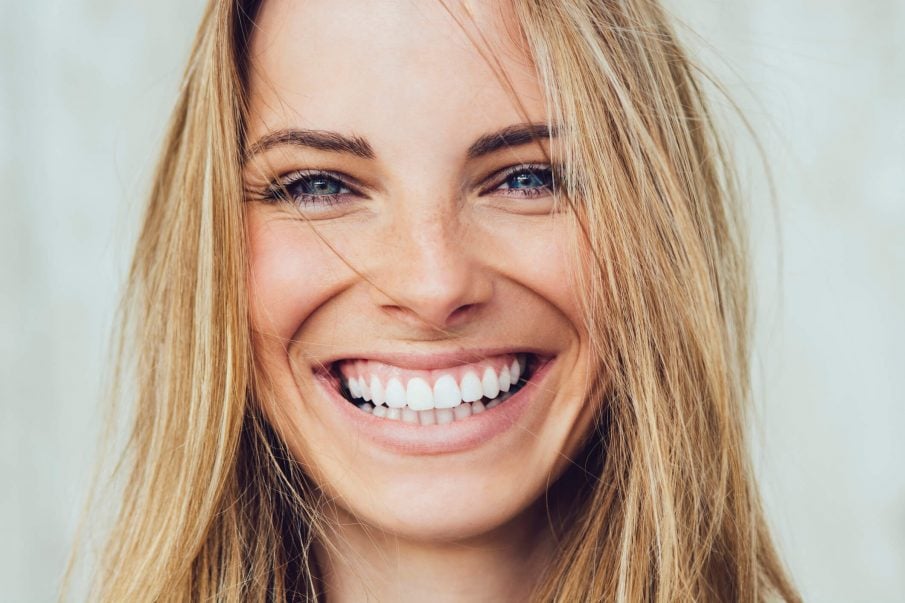 Happy Kind and Timid Young Attractive Woman with Gapped Teeth