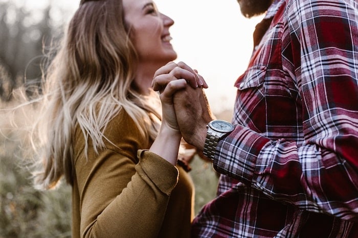 couple outside facing holding hands is he in love with me?