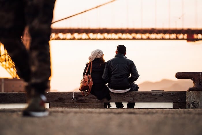 couple sitting on bench outside first date tips for women