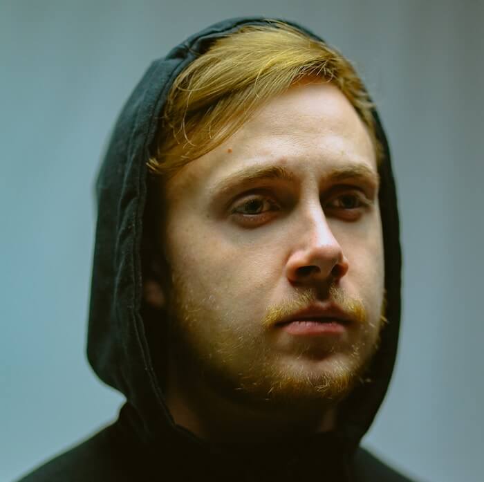 man sitting in black jacket alone lack of empathy