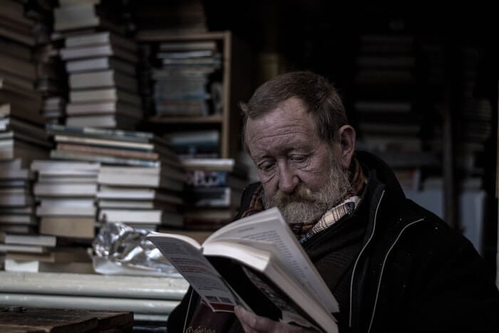 older man reading a book self-improvement