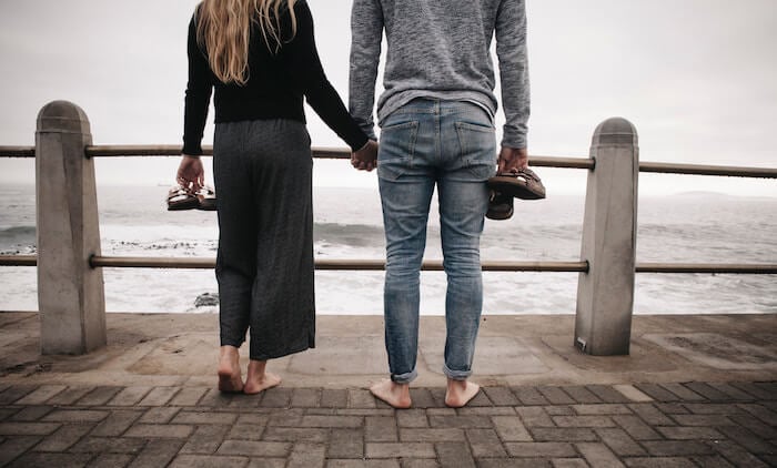 man and woman holding hands at ocean Am I in Love?