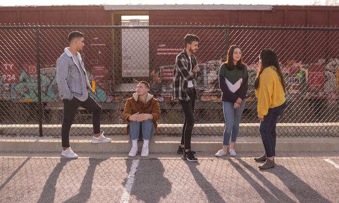 group of people near fence how to make small talk