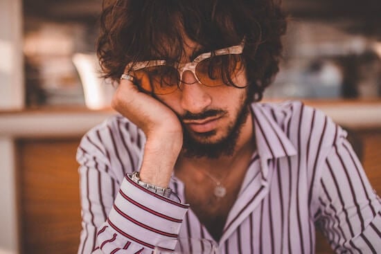 man sitting at table no motivation