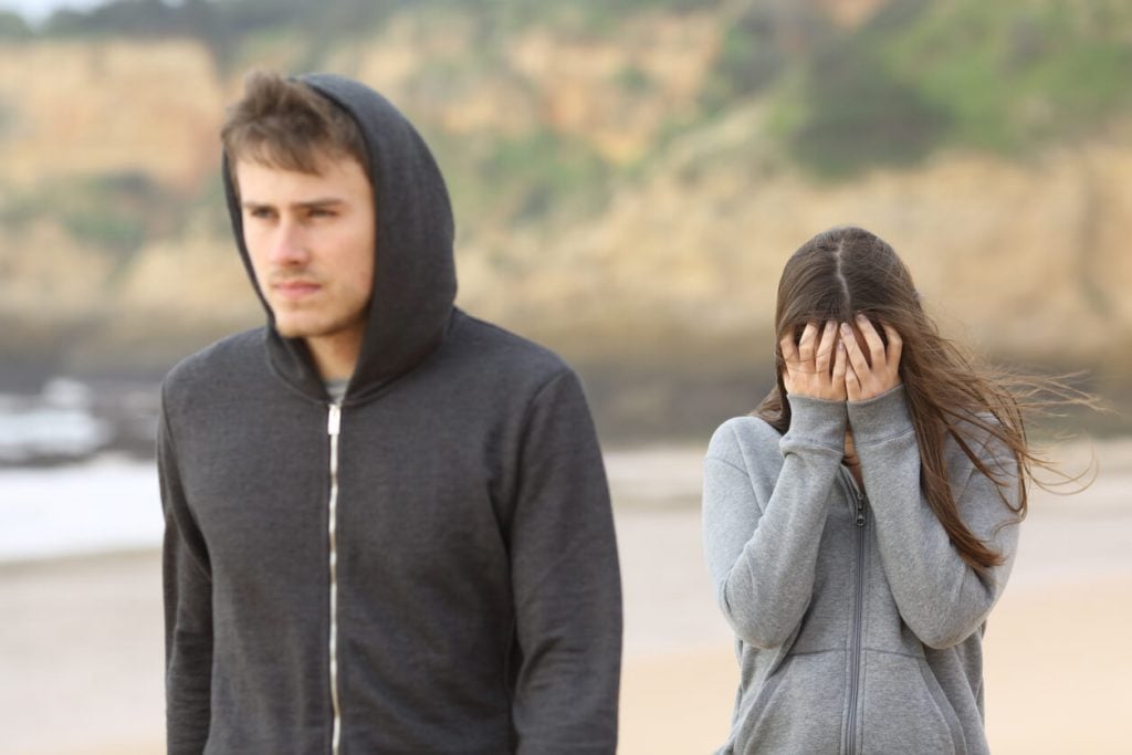 man walking away from woman, how to fix trust issues in a relationship