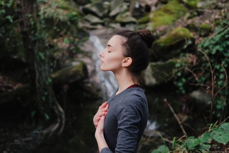 woman standing by waterfall Everything Will Be Okay