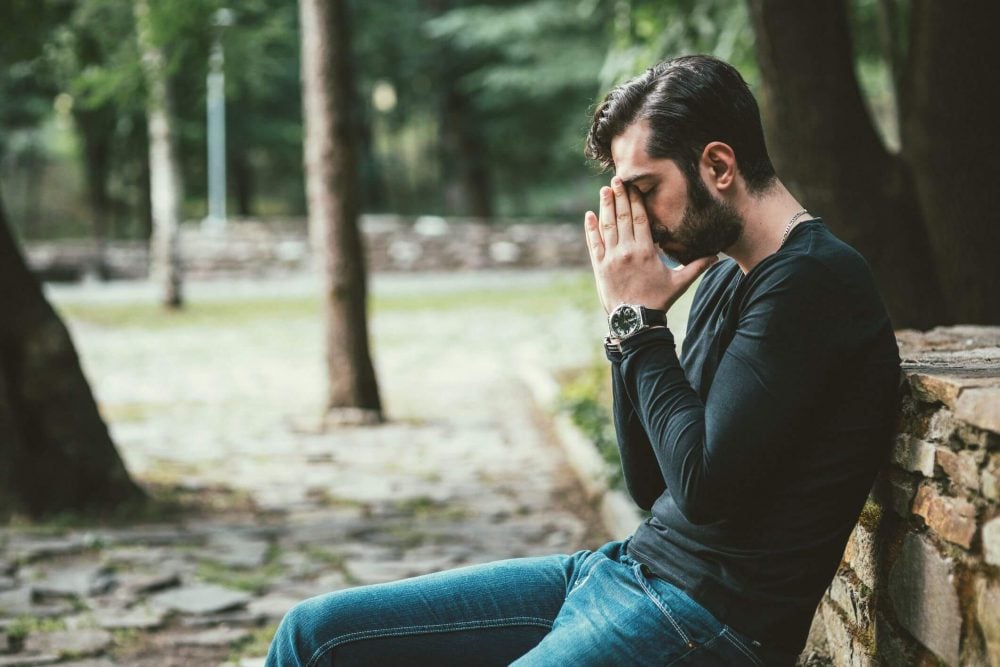 upset man sitting on bench i dont matter