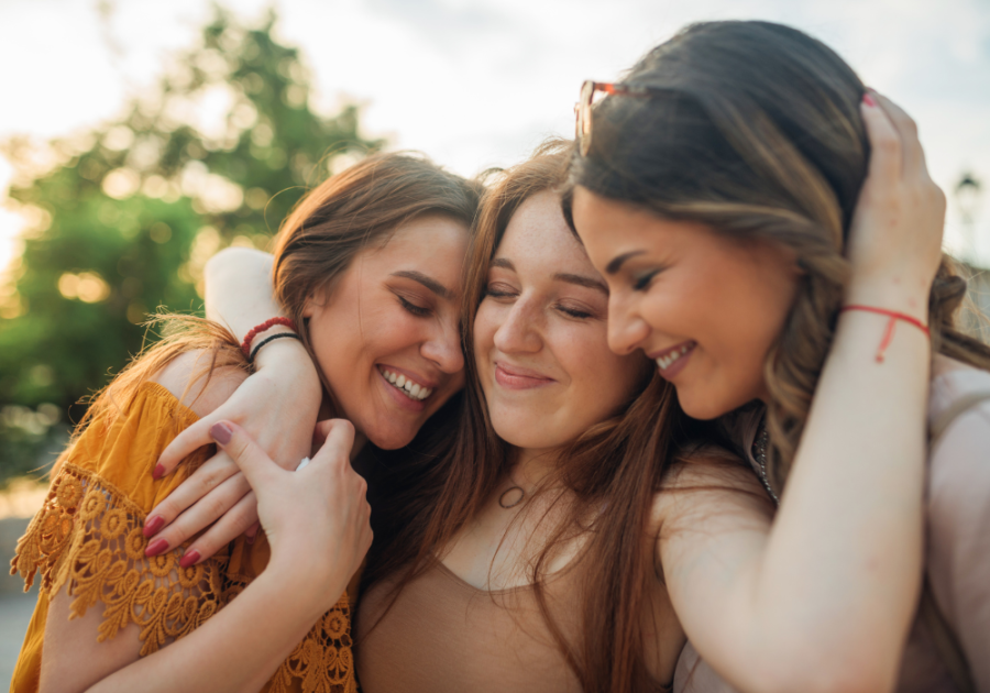 group of friends hugging warm personality traits