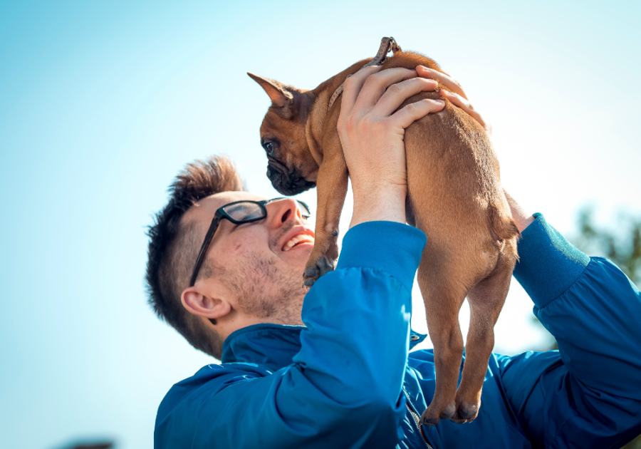 man cuddling his cute dog what makes you smile