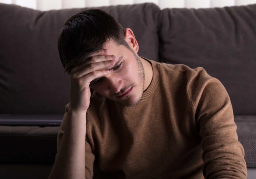 man sitting on sofa looking sad why does nobody love me