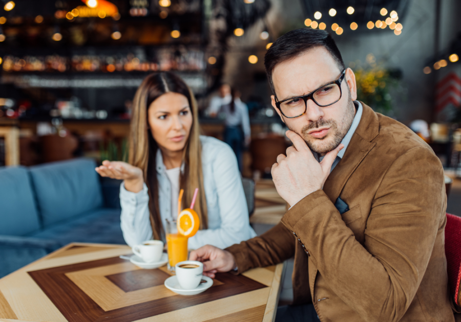 man looking away while in a cafe with a woman signs of a player