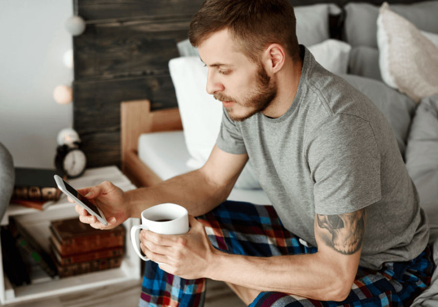 man sitting in pajamas texting how to respond to a narcissist text