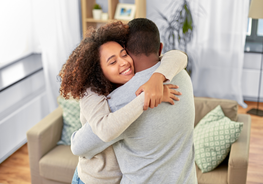 couple hugging in living room 50-50 relationship