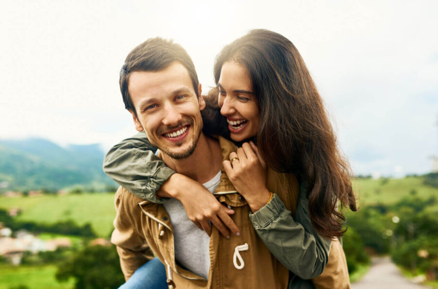 happy couple outside how to be irresistible to men