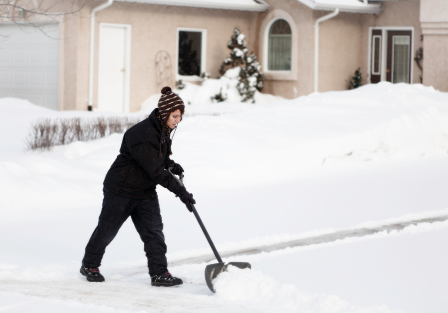 woman shoveling snow Good Excuses To Miss Work On Short Notice