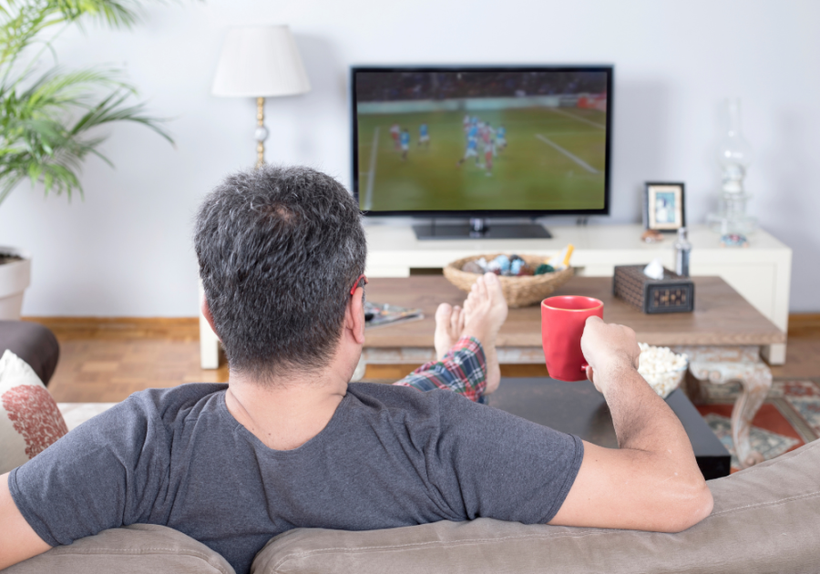 man watching tv on sofa Guilty Pleasure Examples