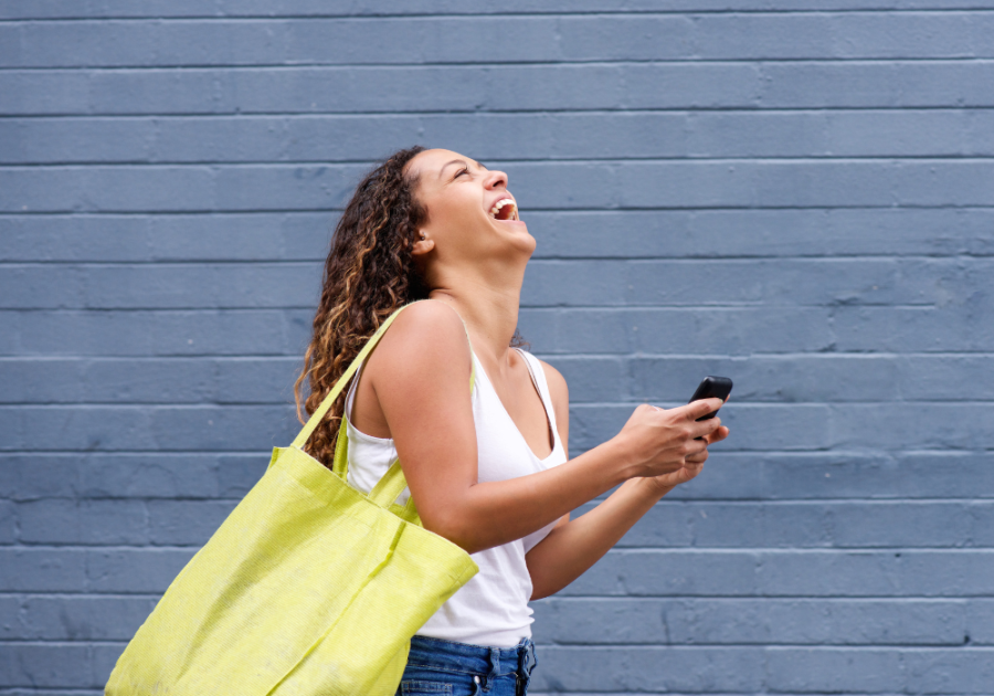 woman laughing walking down street Funny Responses When Someone Asks, "How Are You?"