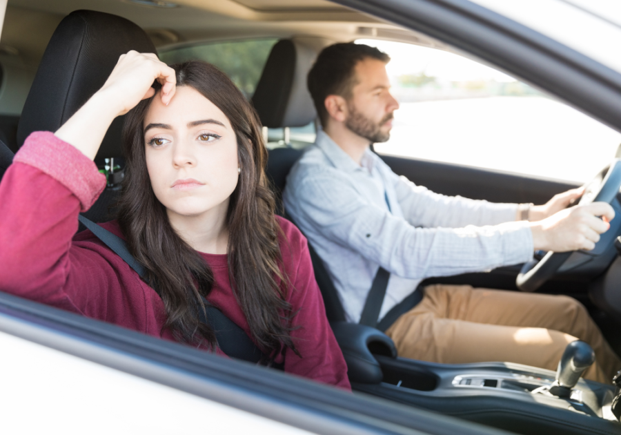 couple sitting in car woman looking out side window arguing being exploited in a romantic relationship