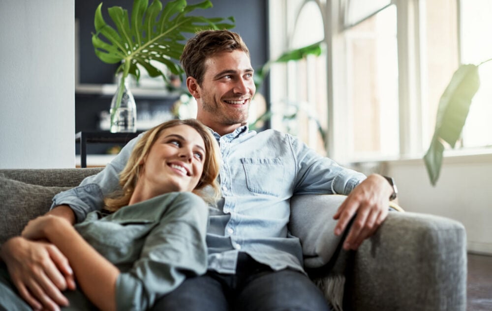 happy couple on sofa non negotiables in a relationship