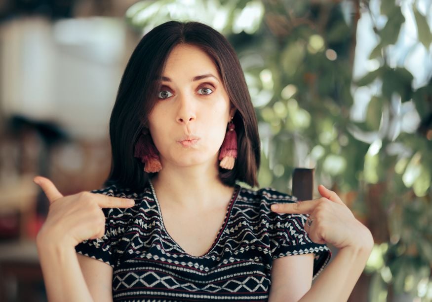 woman headshot pointing to self ambivert personality