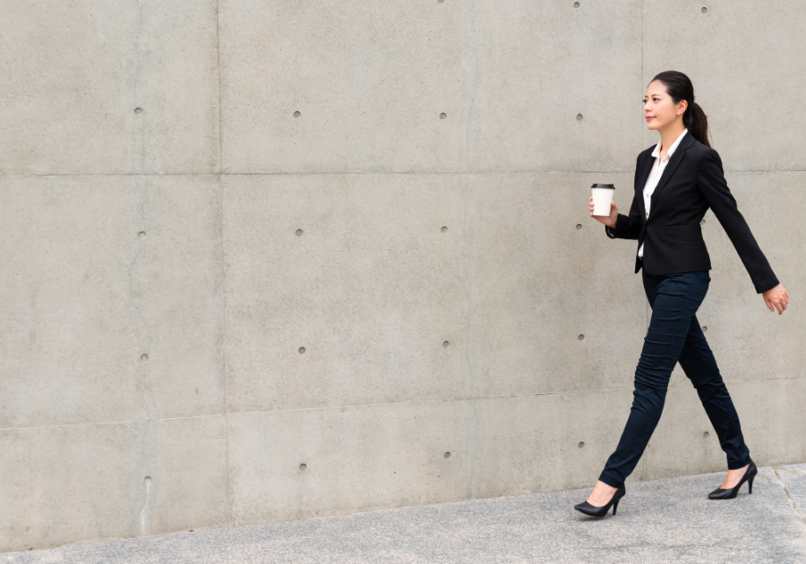 woman dressed in black walking by cement wall Masculine Vs. Feminine Energy