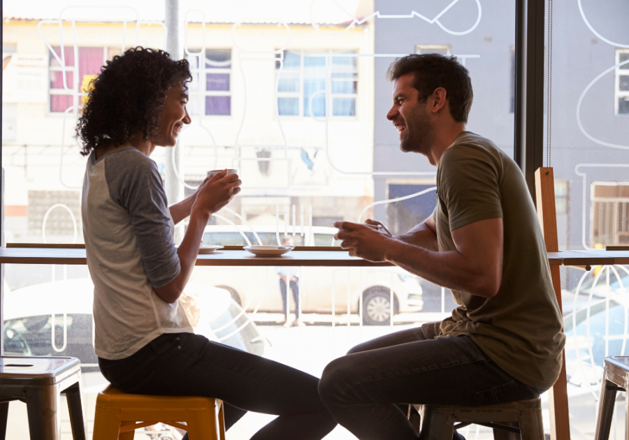 couple having coffee by window friends to lovers