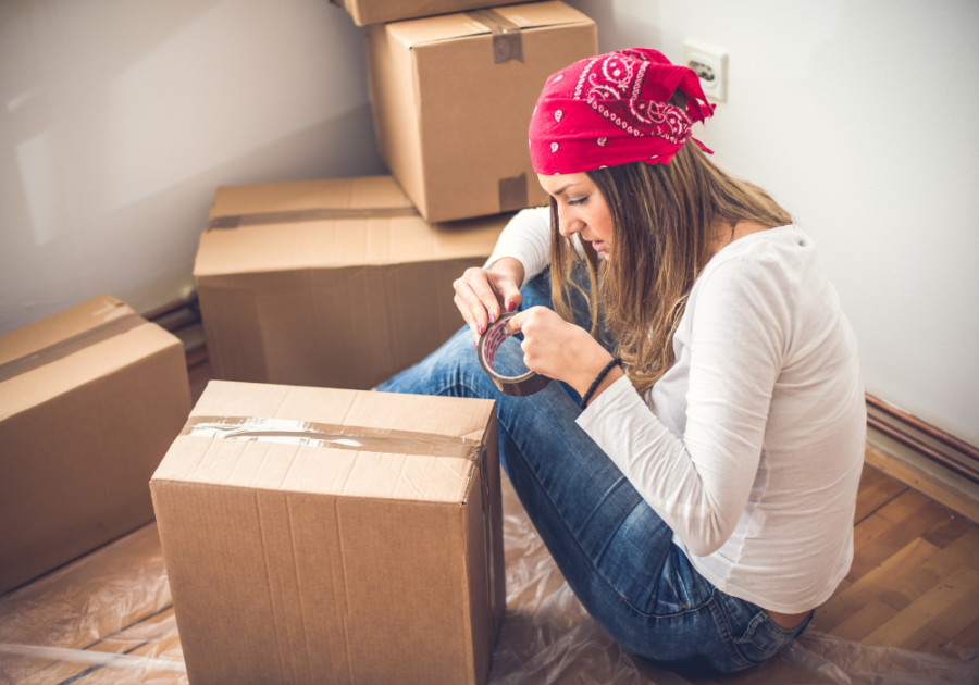 woman sitting on floor taping box Walkaway Wife Syndrome