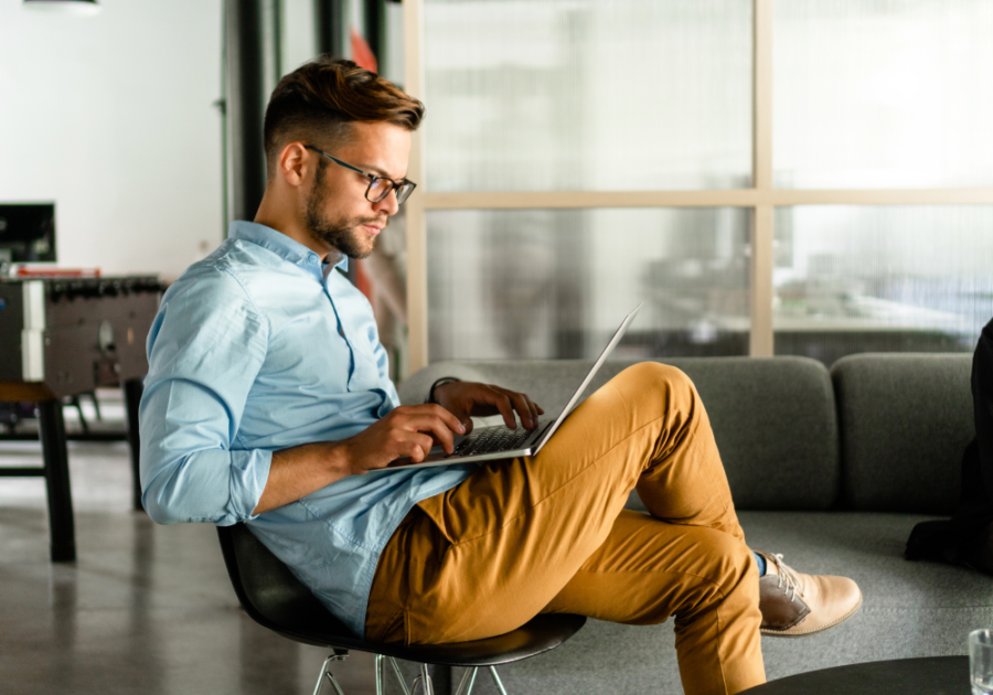 man typing on laptop Best Tinder Bios for Guys