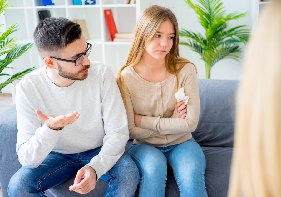 couple talking on sofa woman has been crying how to deal with insecurities in a relationship