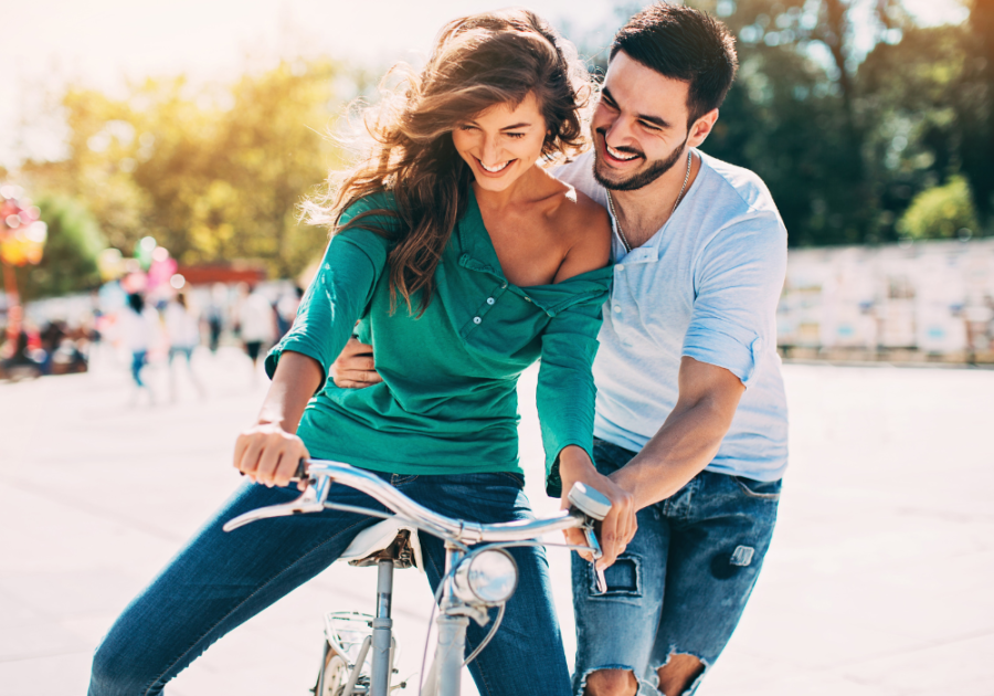 couple laughing while she ride bike Signs He Sees You As Special