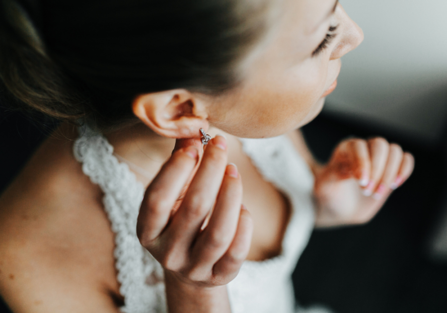 woman putting on earrings Signs Your Wife Is Cheating