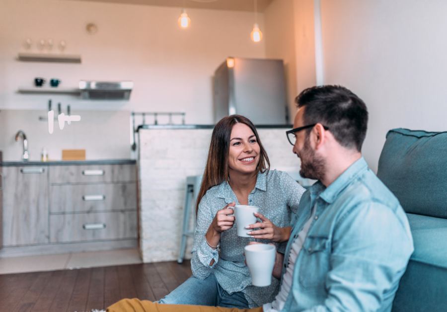 Couple sitting next to sofa on the floor and talking