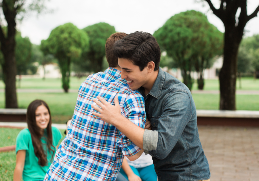 two guys hugging and greeting each other how to respond to what's up