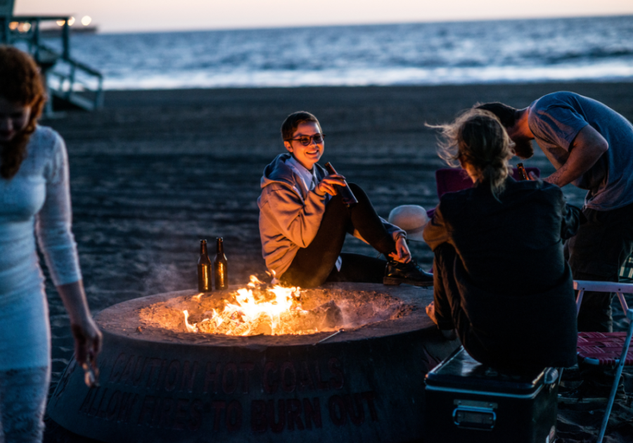 group on beach with fire pit what to do on a Saturday night