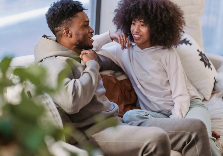 Smiling Couple Sitting On Couch Difficult Relationship Questions