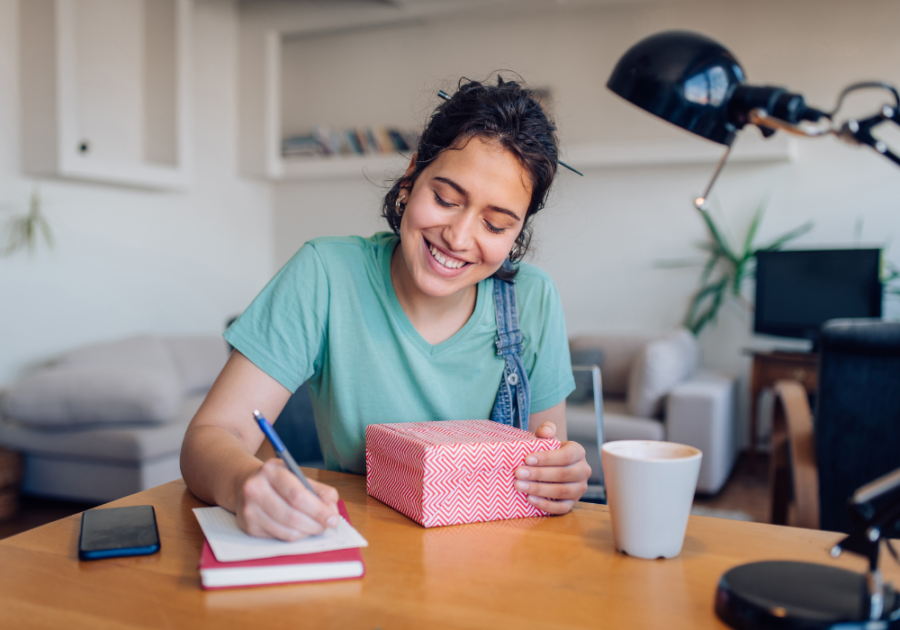 woman sitting at table writing Cute Notes to Write Your Boyfriend