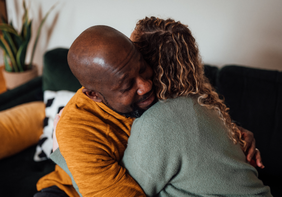 man and woman hugging on sofa Become More Emotionally Available