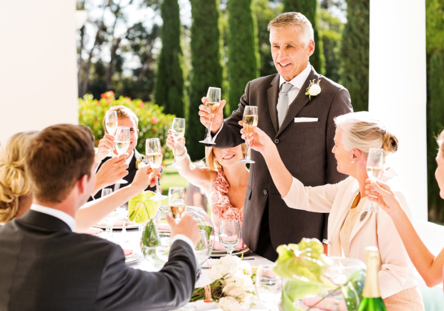 wedding toast at dining table with group Funny Marriage Advice for Newlyweds