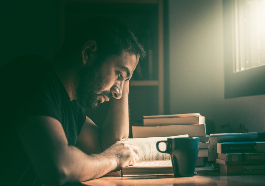 man reading at desk man sitting at desk thinking traits of a stoic personality