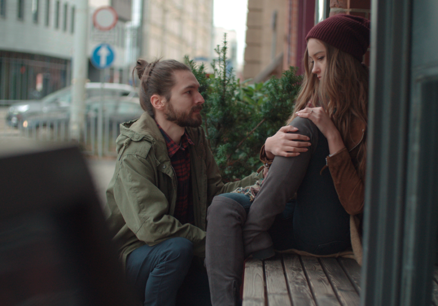 Couple sitting outside on balcony